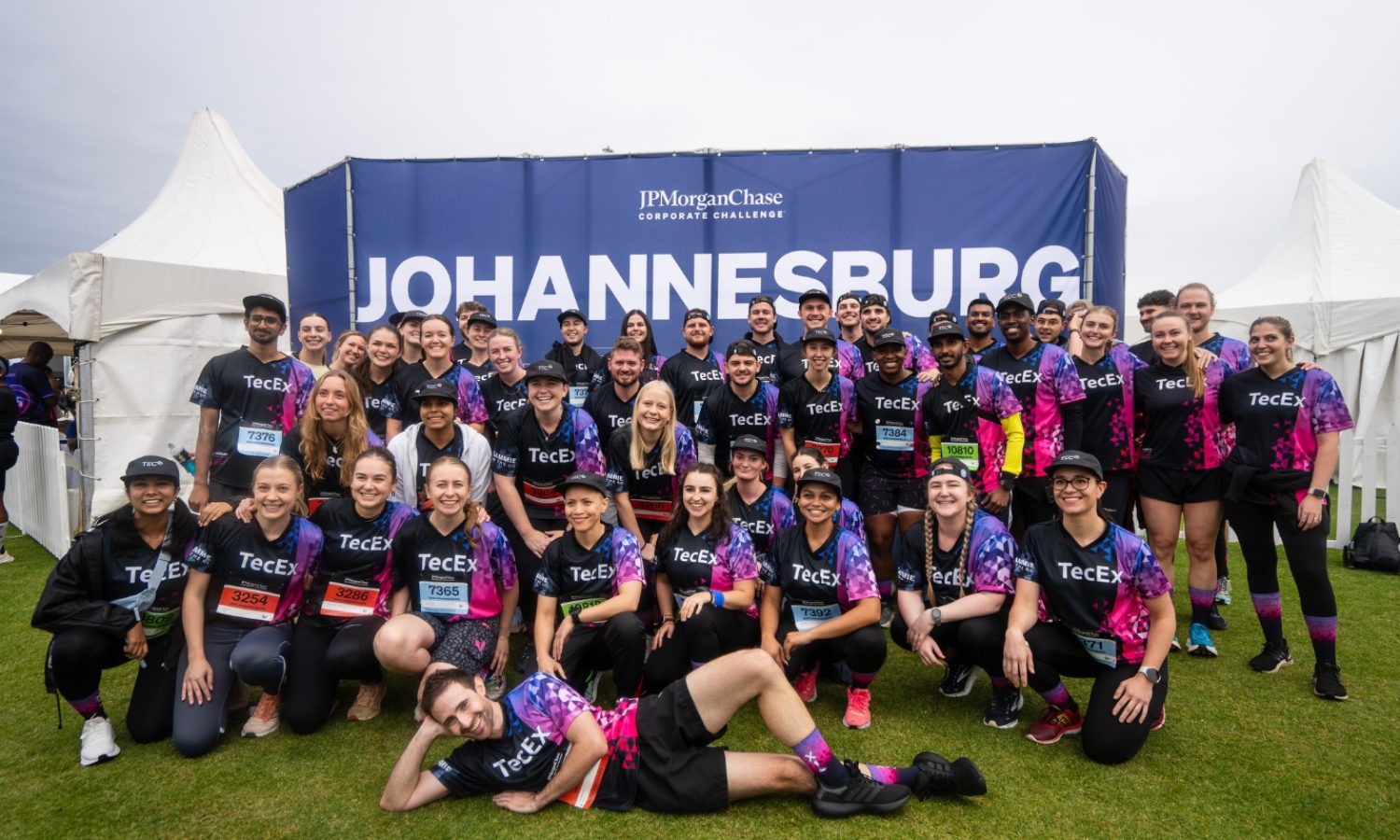 2026 JPMorganChase Corporate Challenge Joburg: team photo in front of the Johannesburg banner