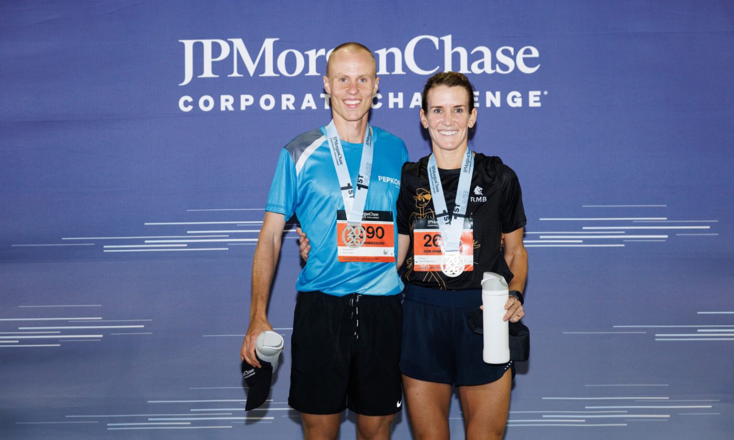 2026 JPMorganChase Corporate Challenge Joburg: two runners in front of the event backdrop